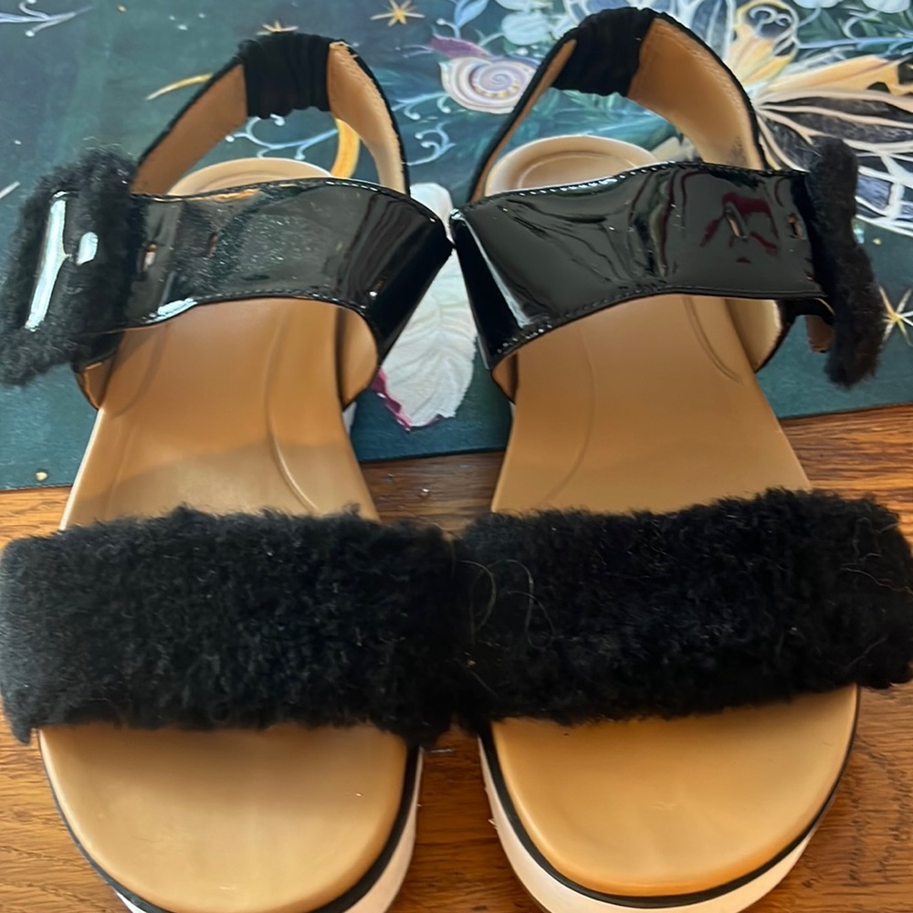 Ugg sandals. Fur in front. Patent leather in back.